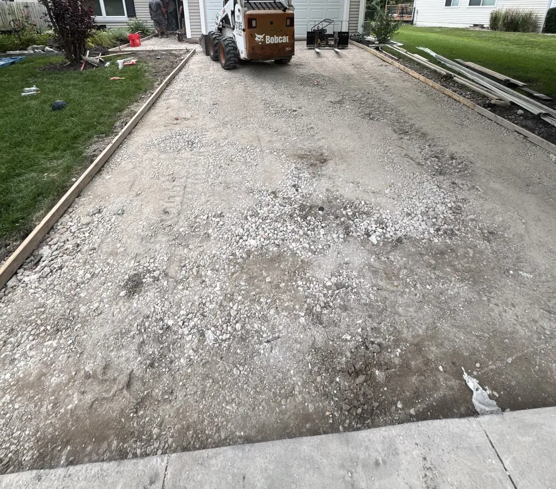 Waukee, Iowa driveway with the old concrete removed, showing compacted granular base and forms set.