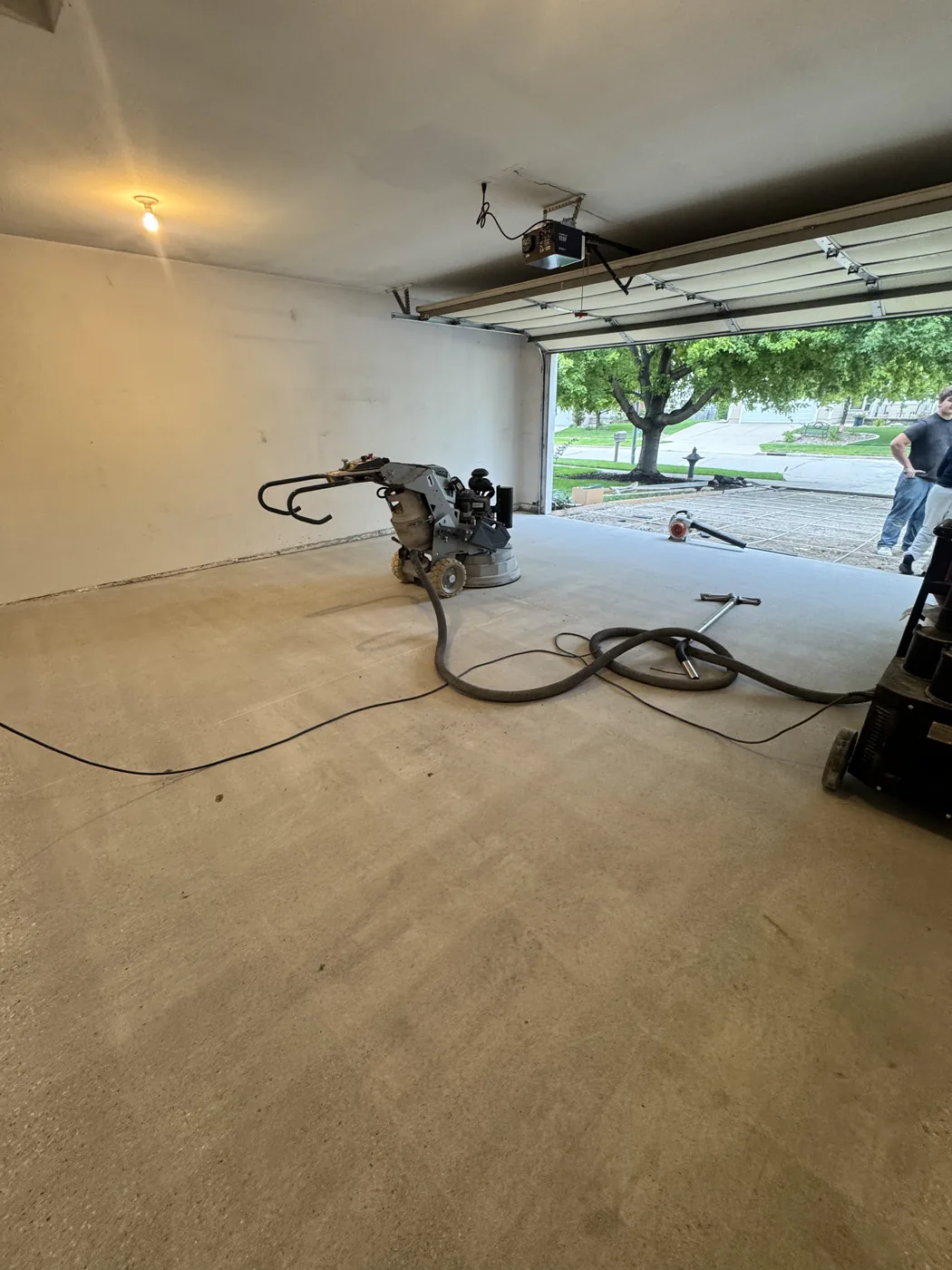 Garage floor in Waukee, Iowa after diamond grinding, prepped and ready to coat.